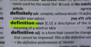 Highlighted dictionary entry: the word 'definition' with its part of speech and description visible on a page.
