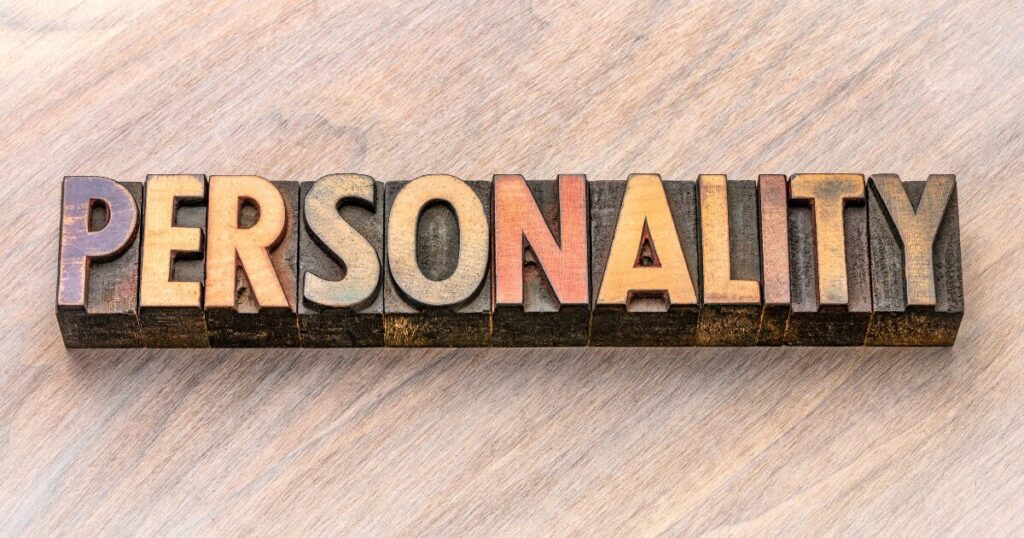 Word 'PERSONALITY' formed by vintage wooden letterpress blocks on a light wooden surface.